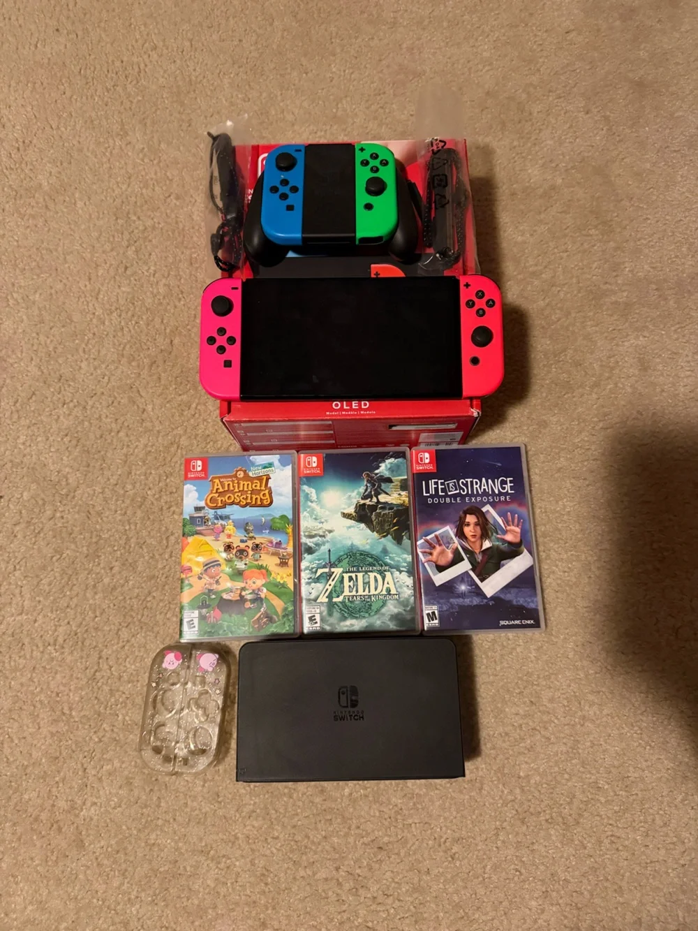 Nintendo Switch OLED with Neon Pink Joy‑Con and Game Titles